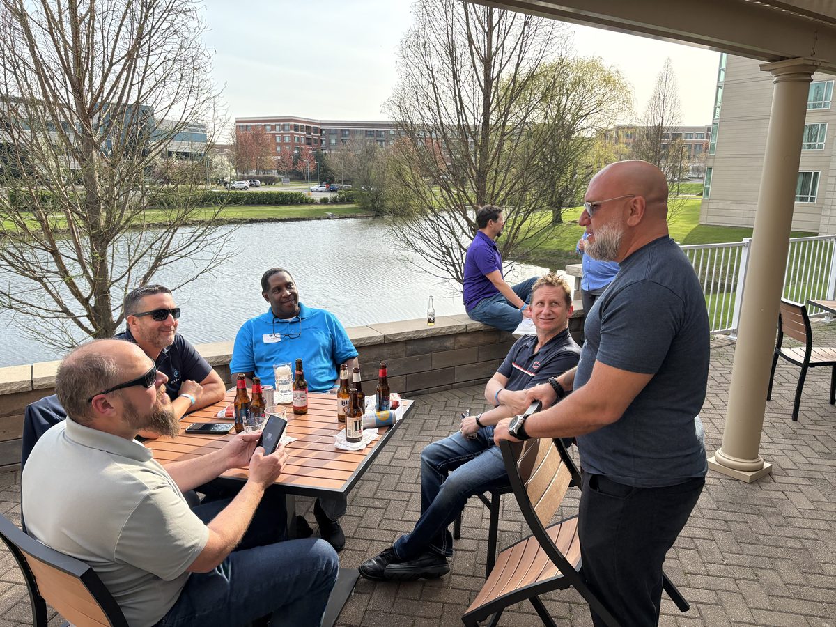 MSP operators networking outdoors over drinks at a CMUG event