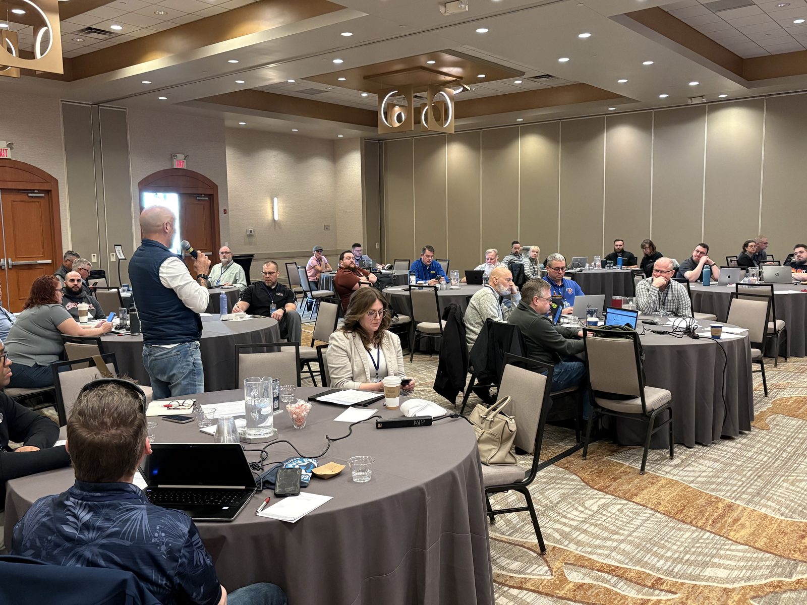 A CMUG regional meetup in session — speaker presenting to a roomful of MSP operators around banquet tables